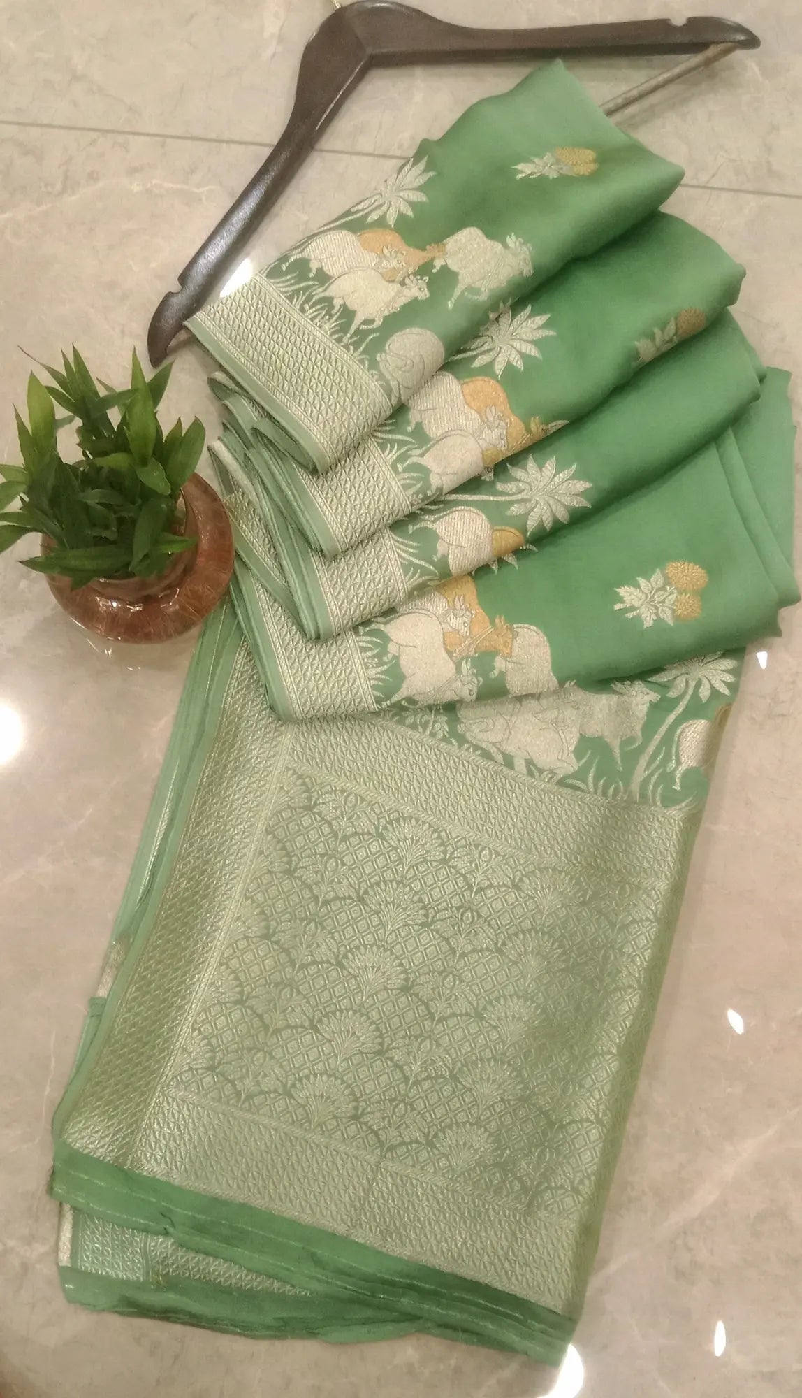 Pastel Green Zari Cow Motif Banarasi Silk Saree with Rich Pallu for Festive & Wedding Wear.